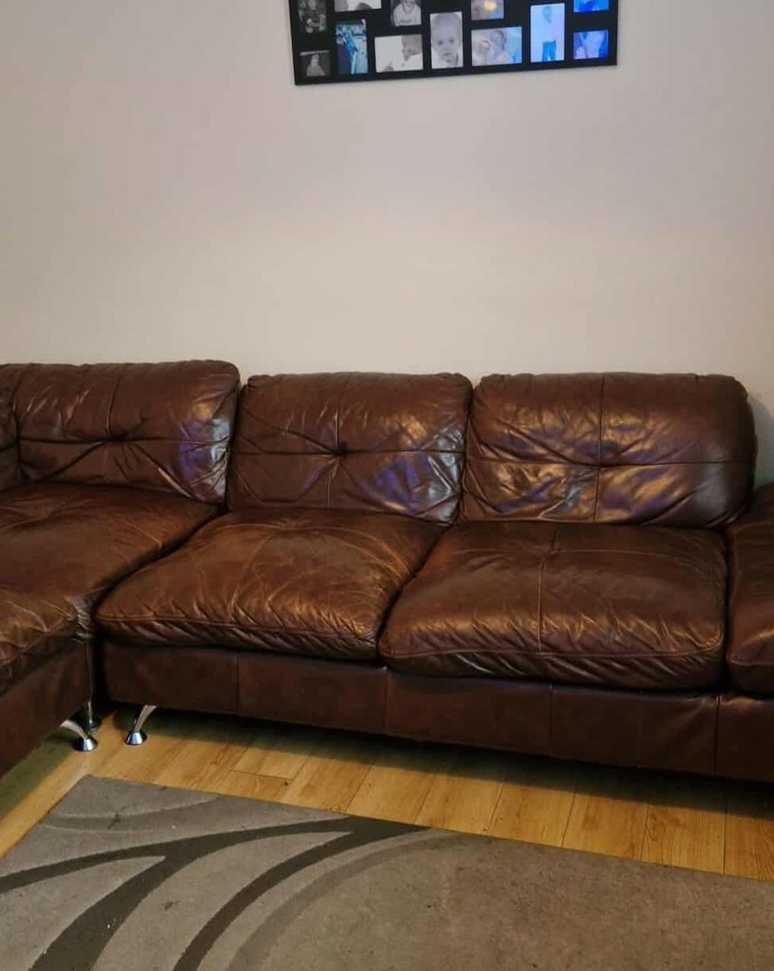 A brown corner sofa on wood flooring, before