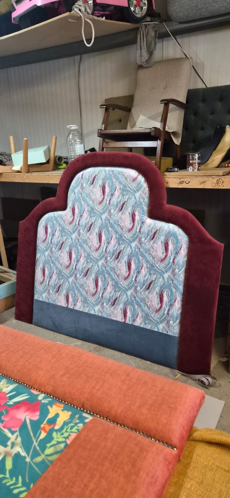 Plain upholstered headboard standing in the workshop